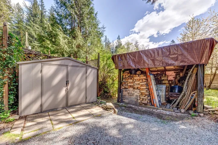 Metal storage shed with double doors situated on a concrete pad
