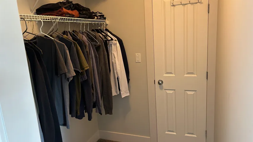 Walk-in closet featuring a wire shelving system and a four-panel interior door