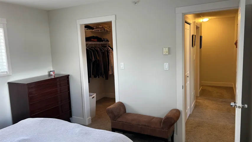 Bedroom featuring a walk-in closet with built-in shelving and hanging rods