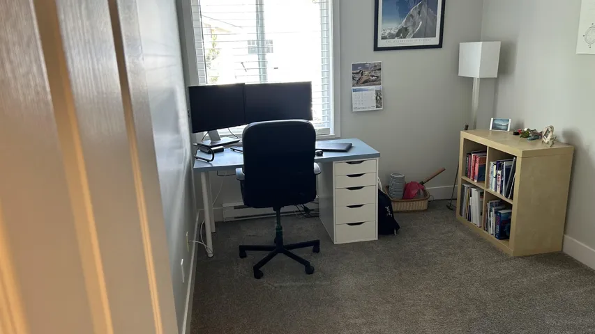 Interior room featuring light gray wall paint, gray carpet flooring, and white trim
