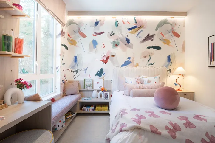 Light-filled bedroom featuring a large window, built-in window seat, and wood-finish flooring