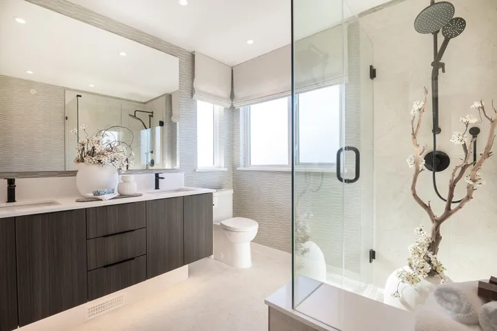 Modern bathroom featuring a dual vanity with a dark wood-finish cabinet, white countertop, and rectangular undermount sinks with matte black faucets