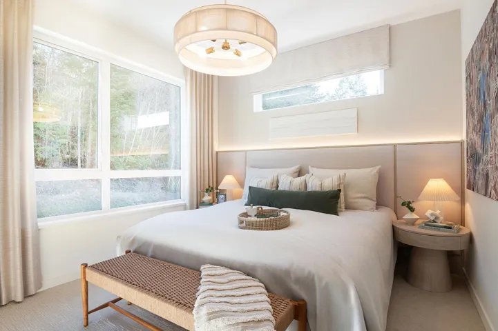 Bedroom featuring an expansive window, transom window, recessed ceiling lighting, upholstered headboard, and a contemporary ceiling fixture