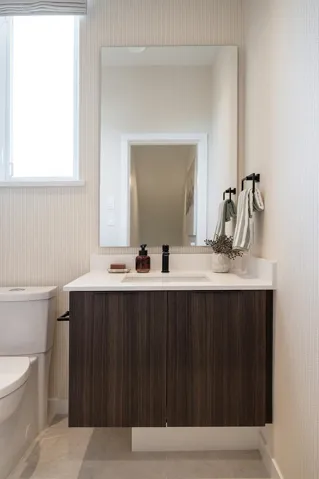 Floating wood-finish vanity with a white countertop and integrated sink