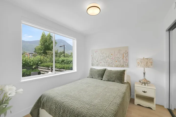 Bedroom with light wood finished floors and a mountain view