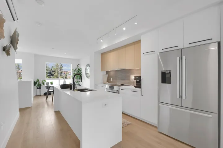 Kitchen with stainless steel fridge with ice dispenser, modern cabinets, and light wood finished floors