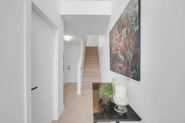 Hall with stairway and light tile patterned floors