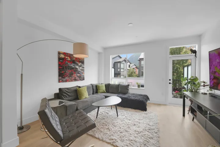 Living area featuring light wood-type flooring and baseboards