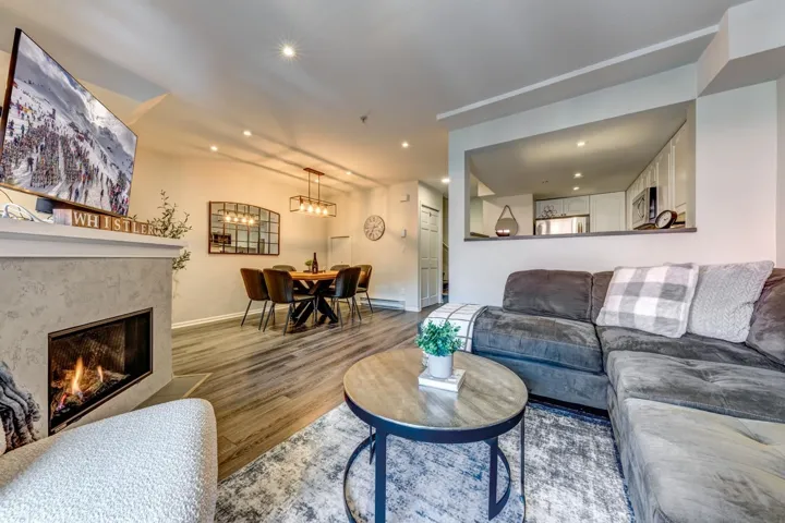 Living area featuring recessed lighting, baseboards, wood finished floors, and a high end fireplace