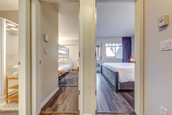 Bedroom with wood finished floors and baseboards