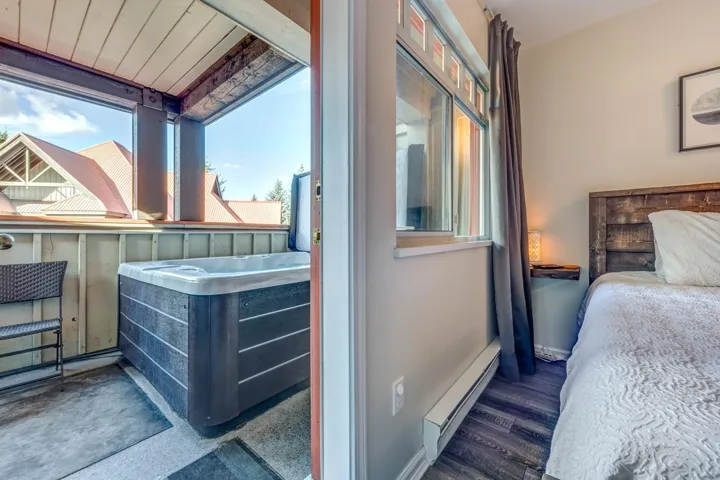Bedroom with a baseboard radiator, baseboards, and wood finished floors