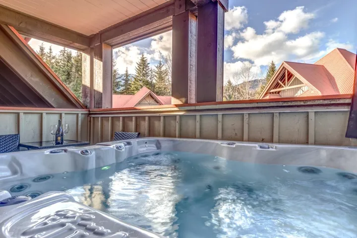 View of pool with a hot tub