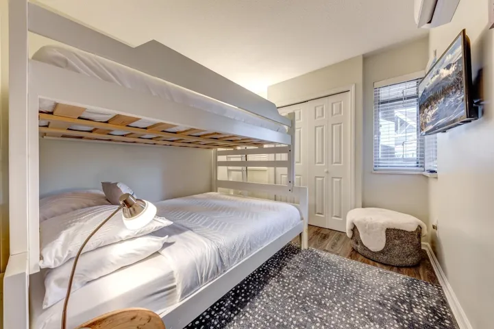 Bedroom featuring a closet, baseboards, and wood finished floors