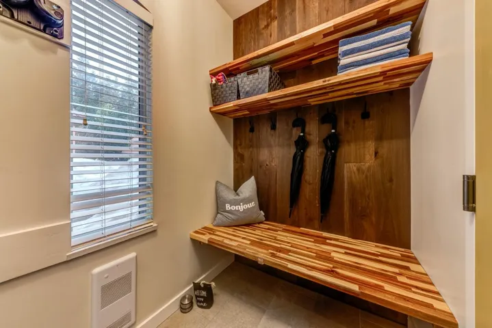 Mudroom with heating unit, a healthy amount of sunlight, and baseboards