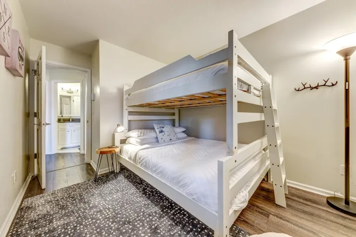 Bedroom featuring wood finished floors and baseboards