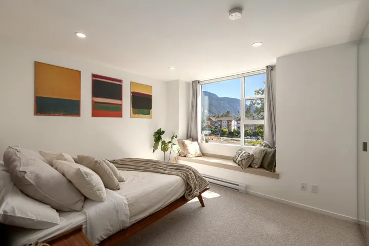 Spacious interior featuring a large window with a built-in window seat, recessed ceiling lighting, wall-to-wall carpeting, and a built-in wall heater