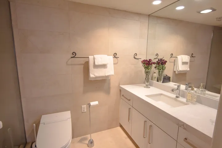 Full bath featuring tile walls, vanity, and recessed lighting