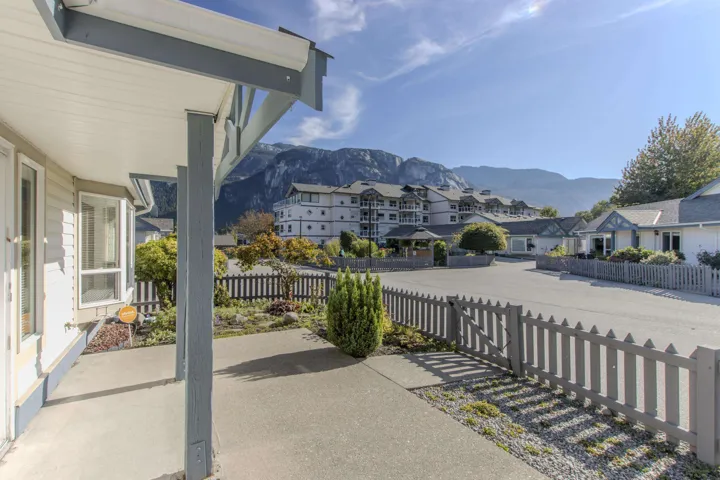 Covered porch featuring a residential view and a mountain view