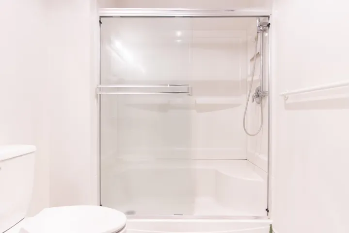 Full bathroom with a shower stall and toilet