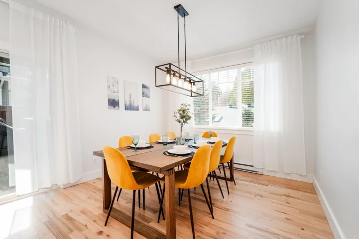Dining space with light wood-style floors, baseboards, and a baseboard heating unit