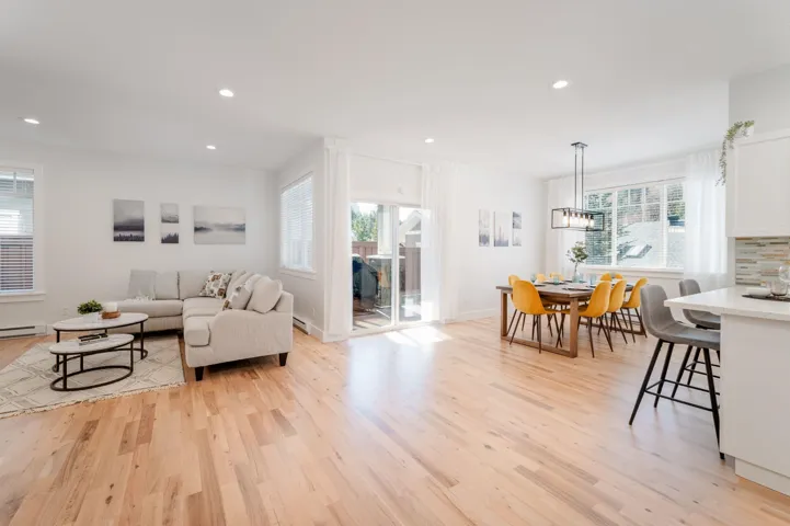 Living area featuring light wood-style flooring, recessed lighting, and a chandelier