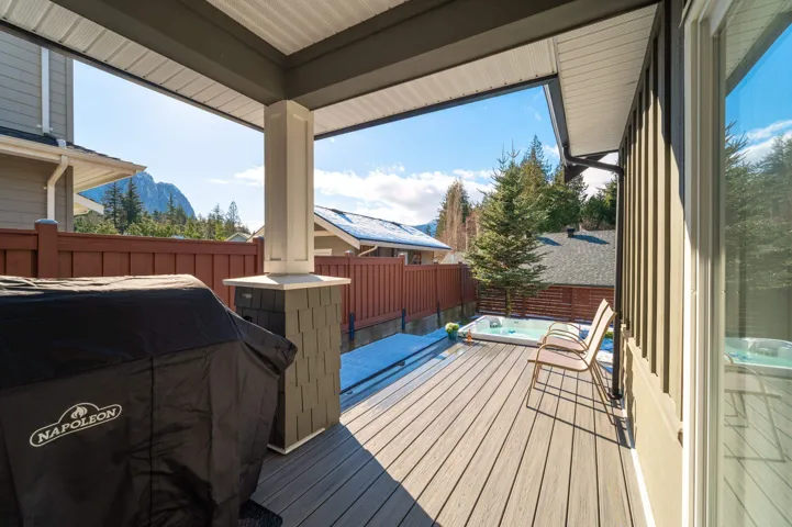 Wooden terrace featuring fence