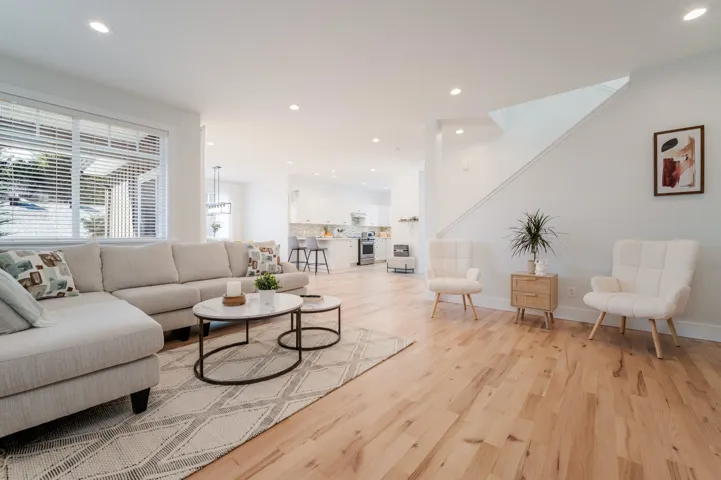 Living area with light wood-style floors, recessed lighting, and baseboards