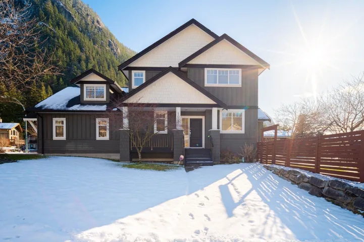 View of front of home with a porch and fence