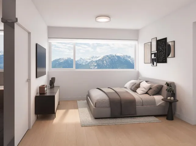 Bedroom with light wood-style flooring, multiple windows, and baseboards