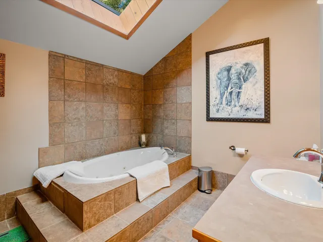 Large jacuzzi soaker tub and radiant tile floors.