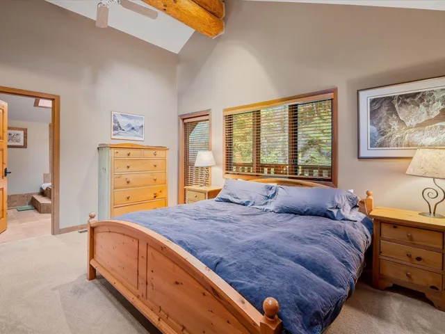 Large primary bedroom with ensuite, vaulted ceilings, skylight and a private deck.