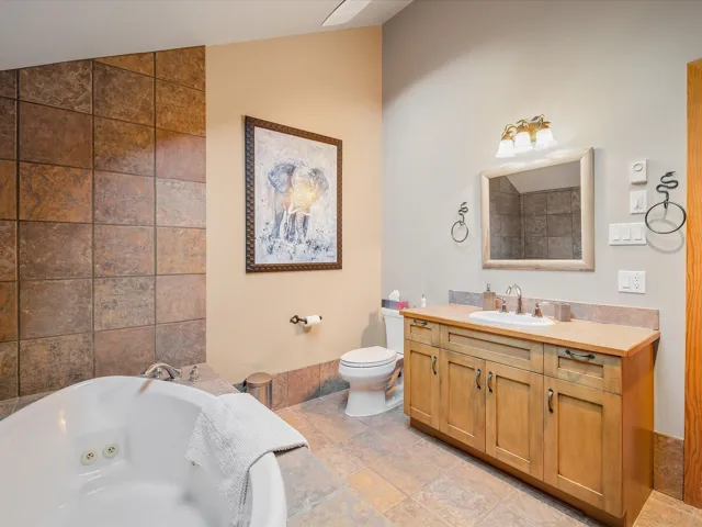 Large jacuzzi soaker tub and radiant tile floors.