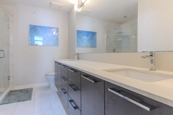 Oversized primary en-suite bathroom with vanity and large walk in shower.