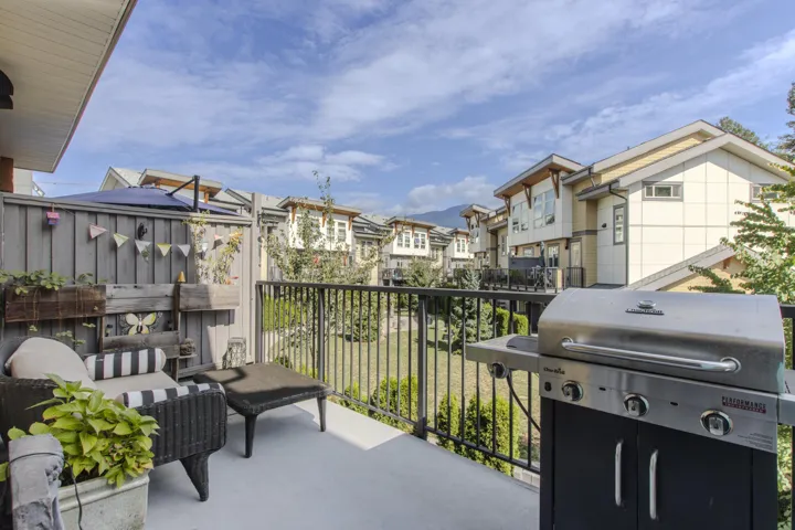 Balcony with area for grilling and view to landscaped courtyard....perfect to watch the kids play...