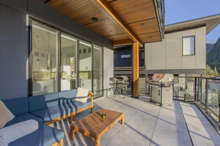 View of patio with grilling area and an outdoor living space
