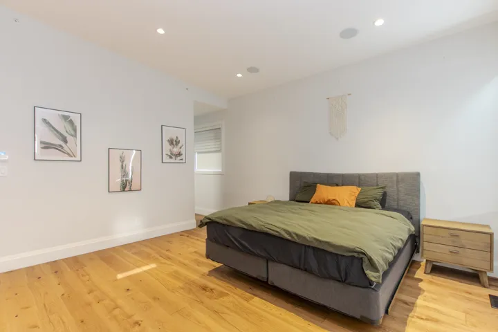 Bedroom with light wood-style floors and recessed lighting