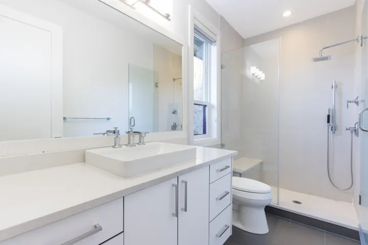 Full bathroom featuring vanity, a shower stall, and dark tile patterned floors