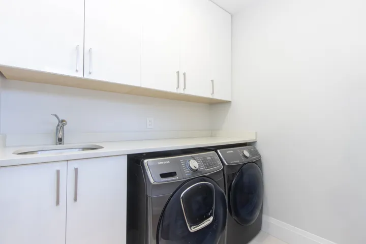 Laundry area featuring cabinet space and washing machine and dryer