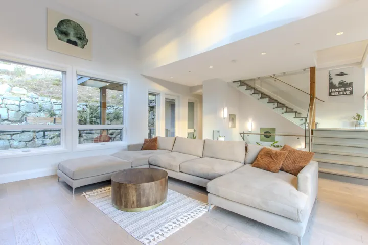 Living area with stairway, hardwood / wood-style floors, and recessed lighting