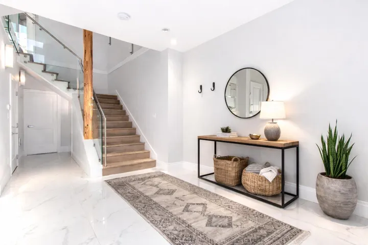 Entrance foyer featuring stairs and light marble finish floors