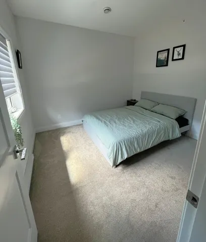 Carpeted bedroom with baseboards