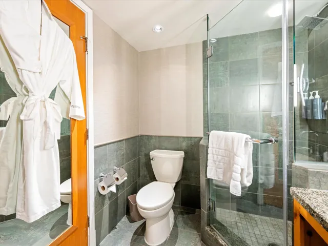 Bathroom featuring tile walls, vanity, a stall shower, and tile patterned floors