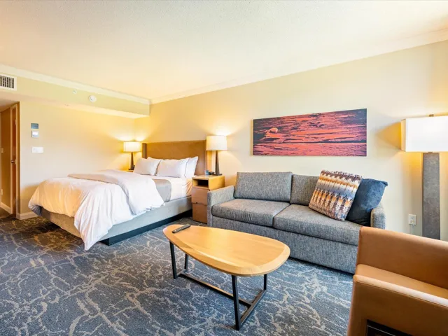 Carpeted bedroom featuring crown molding and baseboards