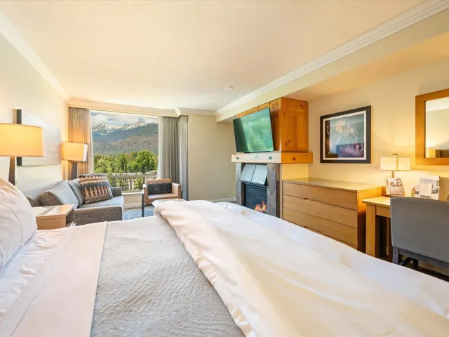 Bedroom featuring a large fireplace, ornamental molding, and access to outside