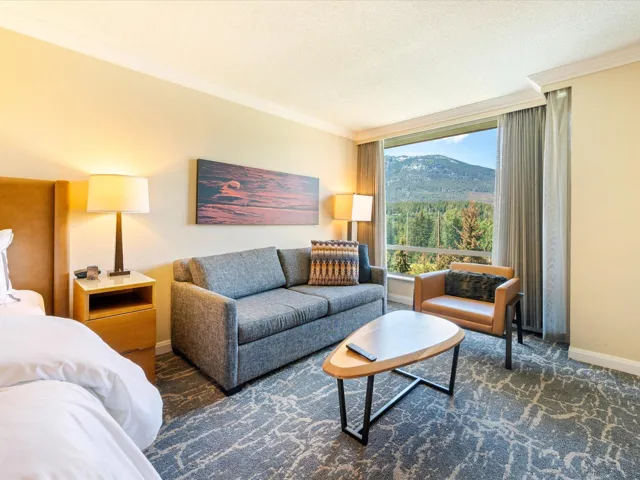Carpeted living area with crown molding, a textured ceiling, and a mountain view
