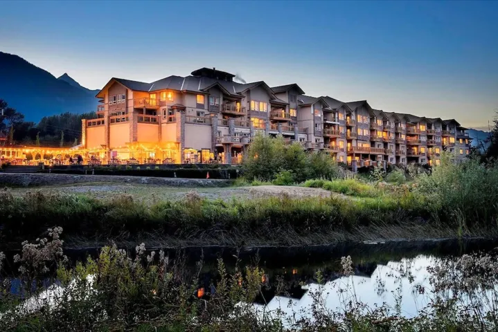 Property at dusk featuring a water and mountain view
