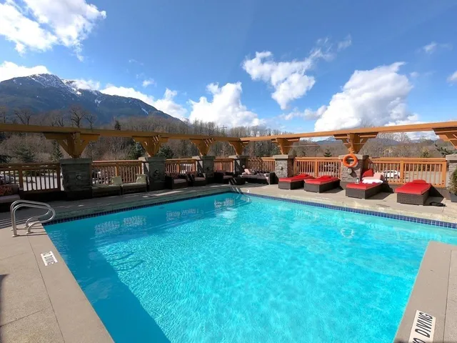 Community pool featuring outdoor lounge area and a deck with mountain view