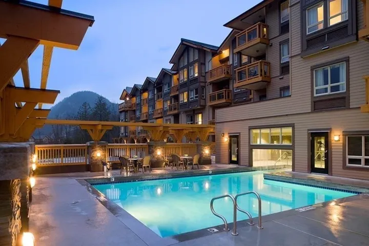 Community pool featuring a mountain view and a patio