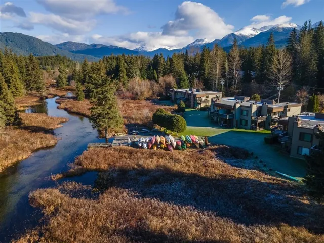 View of property's community with a water and mountain view and a wooded view
