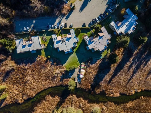 Aerial view of property and surrounding area with nearby suburban area